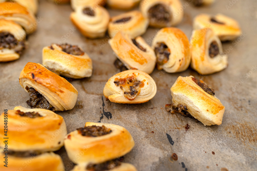 Freshly baked golden patties with mushrooms lying on baking paper. Freshly baked golden patties with mushrooms lying on baking paper.