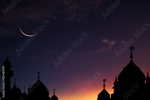 Crescent moon on twilight sky after sundown over dome mosques,Eid al-Adha, Eid al-Fitr photo