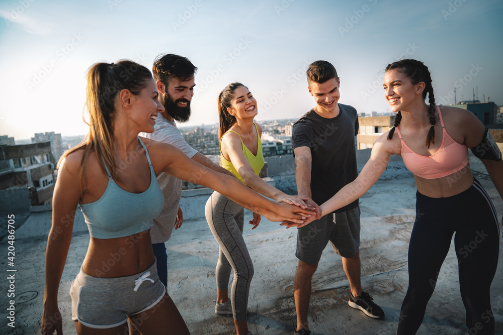 Fitness, sport, training and lifestyle concept. Group of smiling people exercising outdoor - obrazy, fototapety, plakaty 