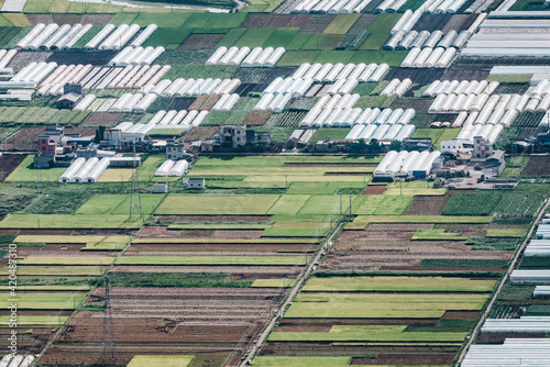 aerial view of agricultural plots of land under cultivation in an agricultural town.