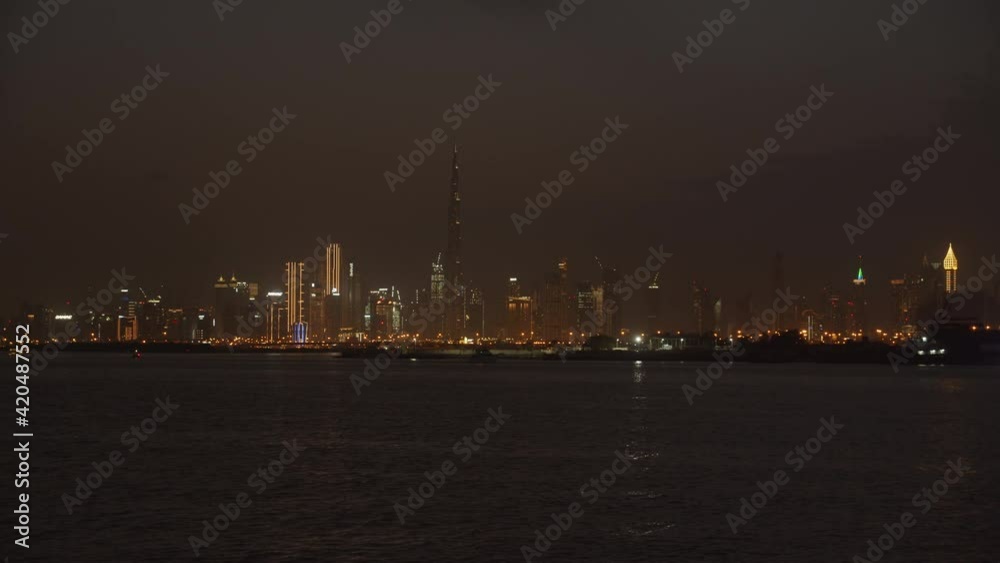 Dubai city skyscrapers at night. Dubai skyline with city lights on tall skyscrapers and Burj Khalifa tourist attraction