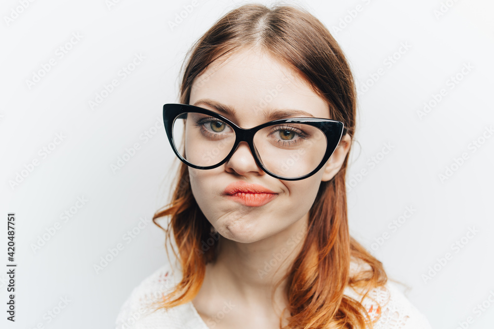 red-haired woman emotions fashionable glasses studio face close up
