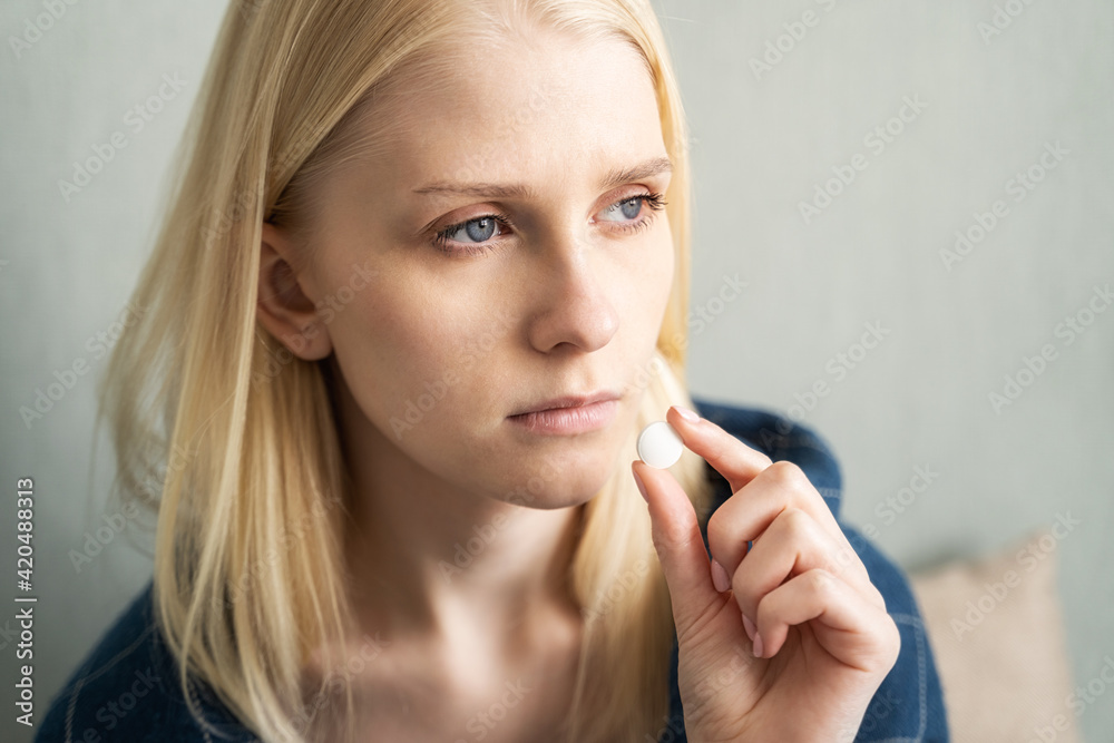 Woman with pills in hands. Medication in capsules and glass of water on a wooden table Woman with pills in hands. Medication in capsules and glass of water on a wooden table