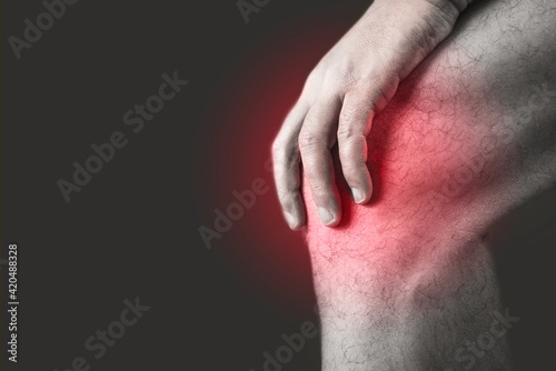 close up of a knee pain point on black background. Copy space