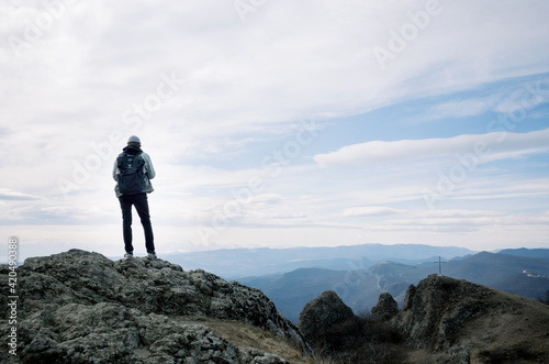 Young man on the top of the hill photo