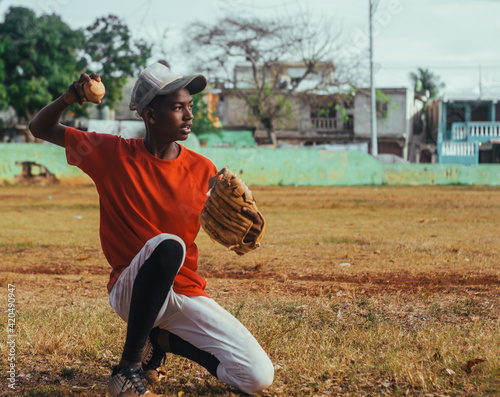 Canvas Print boy with brown skin and latin origin playing baseball in the park with ball, glo