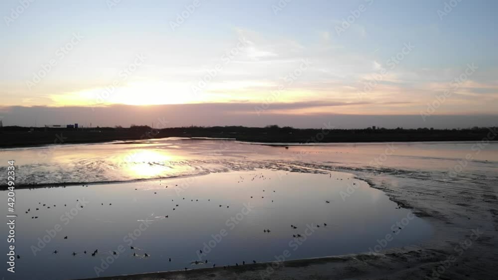 Sunset Reflection On Calm Freshwater Tidal At Crezeepolder In Hendrik-Ido-Ambacht, Netherlands. - aerial Sunset Reflection On Calm Freshwater Tidal At Crezeepolder In Hendrik-Ido-Ambacht, Netherlands. - aerial
