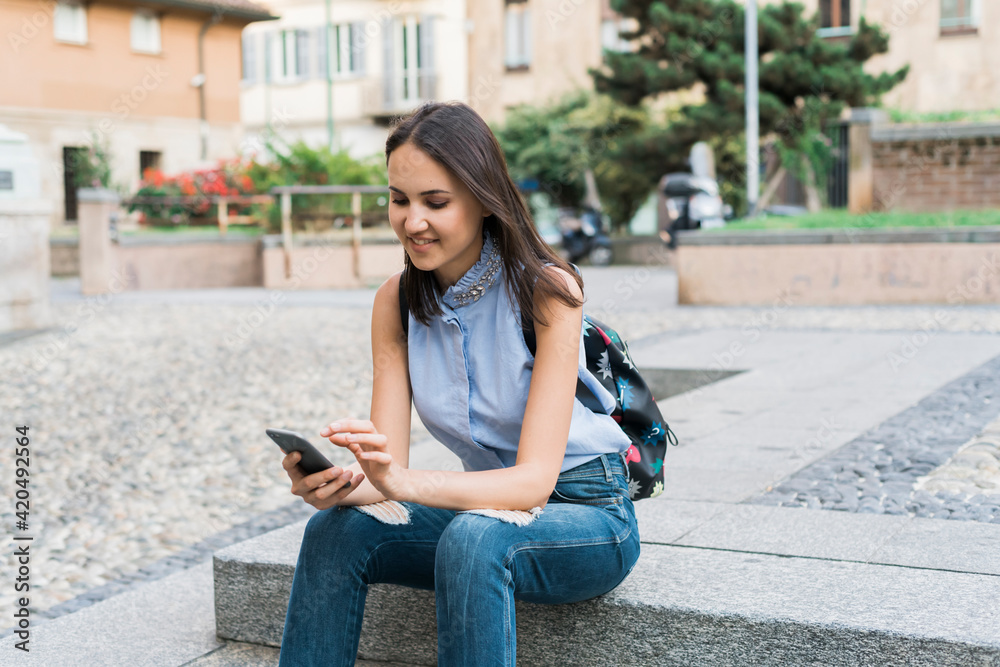 Young woman using a phone in the city Young woman using a phone in the city