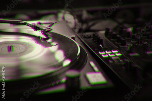 Retro dj turntable player plays vinyl record with music on concert stage photo