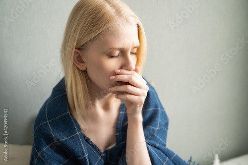 Portrait of a sick woman on the bed at home