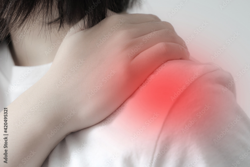 Women holds his shoulder in pain.Healthcare concept
