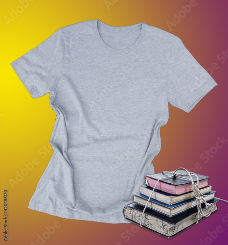 Gray tshirt mockup with stack of books casual fashion clothing on a yellow and purple background with room for text for reading and book lovers.