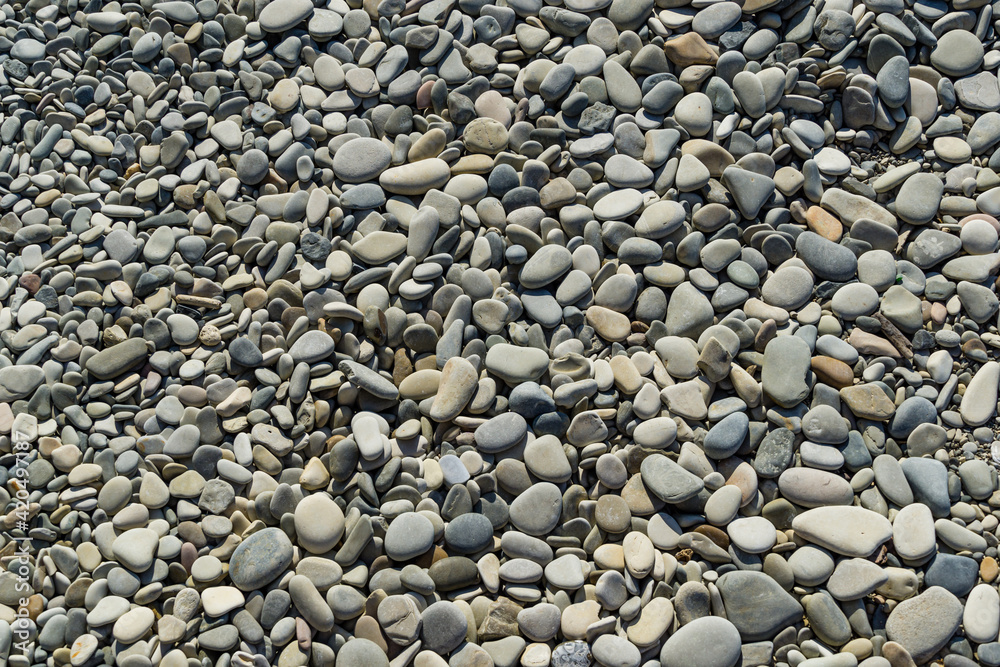 Gray sea pebbles as nature background. Beautiful sea stones of different sizes and texture. Excellent natural concept for any design. Selective focus. Gray sea pebbles as nature background. Beautiful sea stones of different sizes and texture. Excellent natural concept for any design. Selective focus.