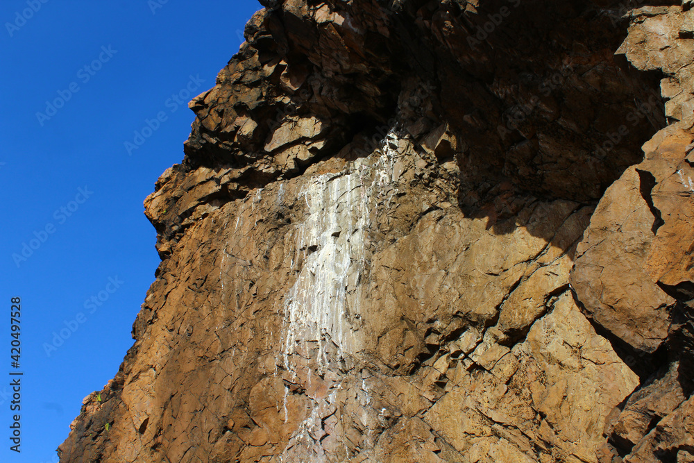 Sheer Rock Wall with Traces of Birds Activity in Wilderness Area Sheer Rock Wall with Traces of Birds Activity in Wilderness Area
