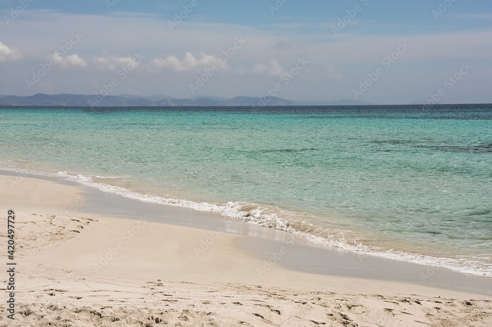 a sunny day at the beach with turquoise water a sunny day at the beach with turquoise water