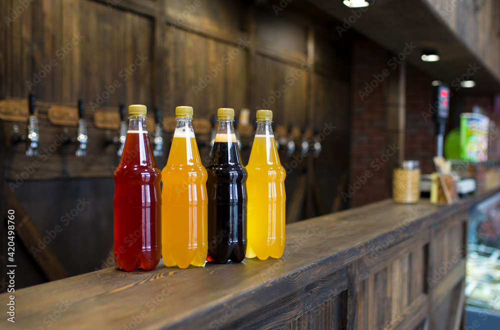 plastic bottles of light and dark beer on a pub counter. Beer background. plastic bottles of light and dark beer on a pub counter. Beer background.