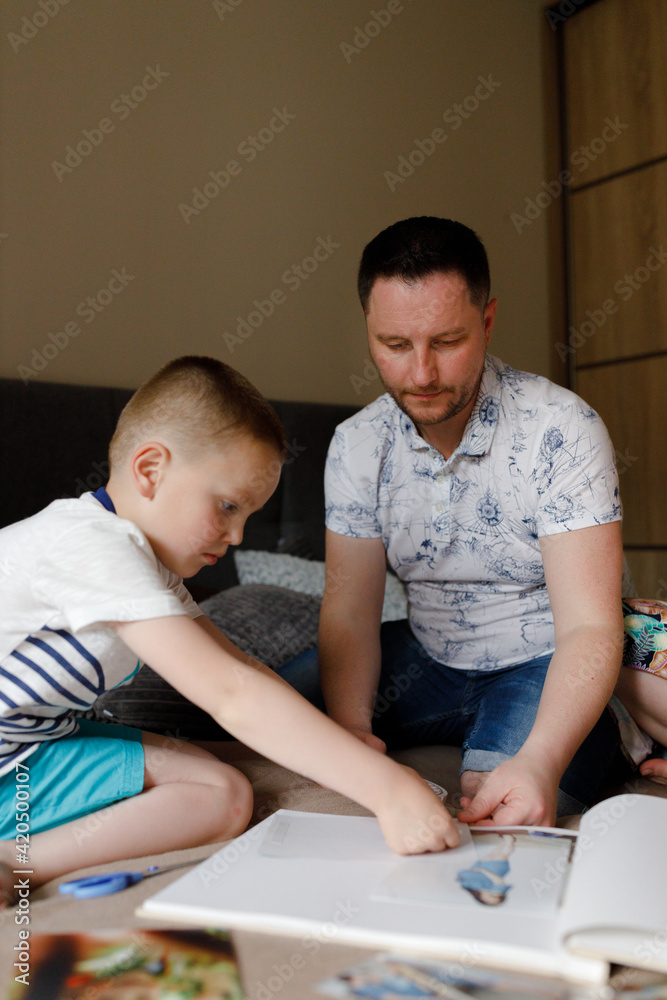 Dad helping child with application Dad helping child with application
