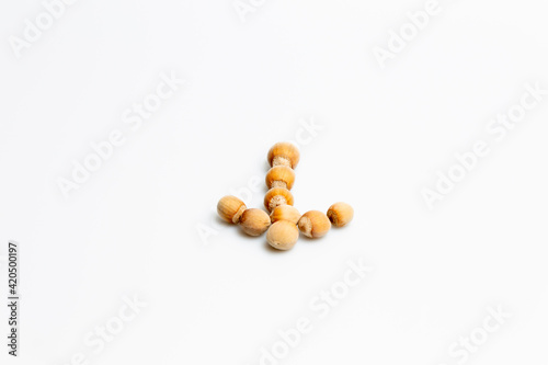 Nuts on a white background with a down arrow shape  © LilianC