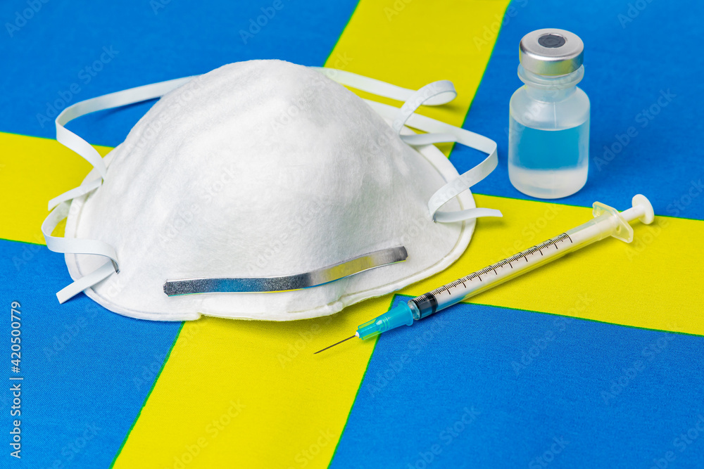 Sweden flag, n95 face mask, needle syringe and vial. Concept of Covid-19 coronavirus vaccine distribution, supply shortage and healthcare crisis Sweden flag, n95 face mask, needle syringe and vial. Concept of Covid-19 coronavirus vaccine distribution, supply shortage and healthcare crisis