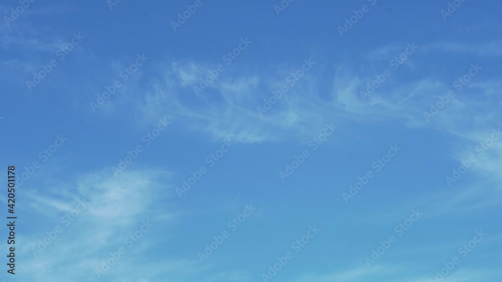 Time Lapse of Light Cirrus Clouds in a Clear Blue Sky During The Day. Good Weather, Clean Ozone Layer. Sky and Light Soft Clouds. Background of Cirrus Clouds and Blue Sky. Time Lapse of Light Cirrus Clouds in a Clear Blue Sky During The Day. Good Weather, Clean Ozone Layer. Sky and Light Soft Clouds. Background of Cirrus Clouds and Blue Sky.