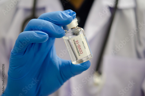 Doctor or laborant holding  COVID-19 vaccine tube Or coronavirus vaccine