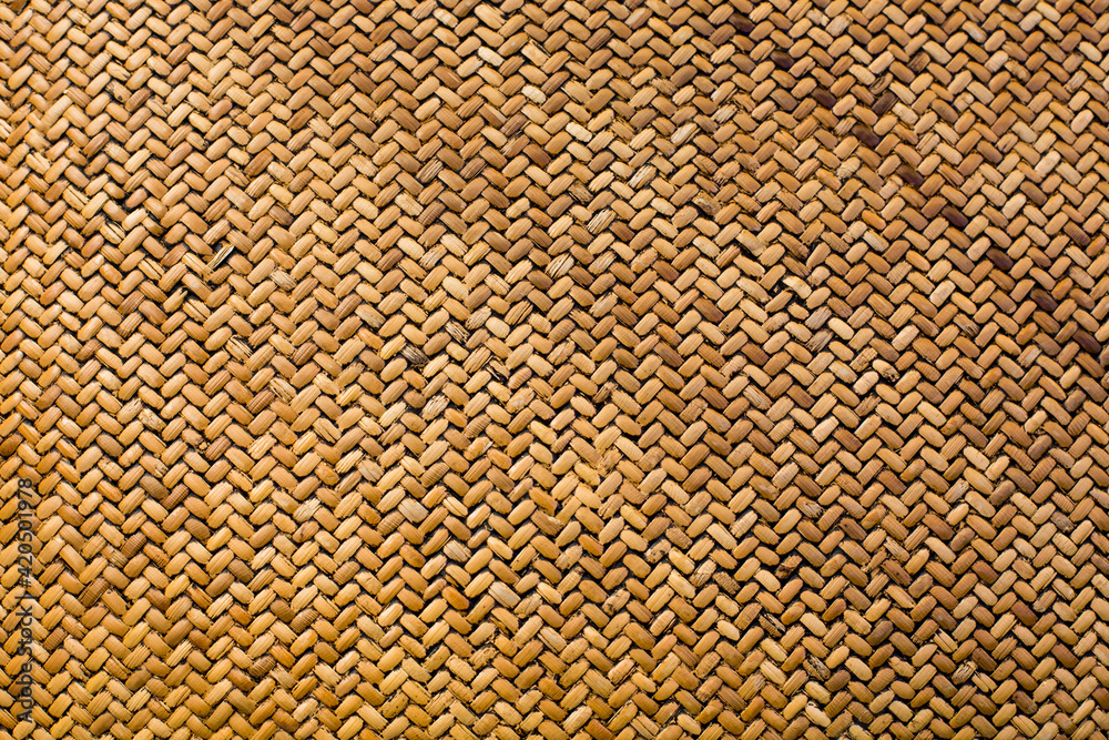 Textured background in the form of weaving from straw material. Horizontal image. Textured background in the form of weaving from straw material. Horizontal image.
