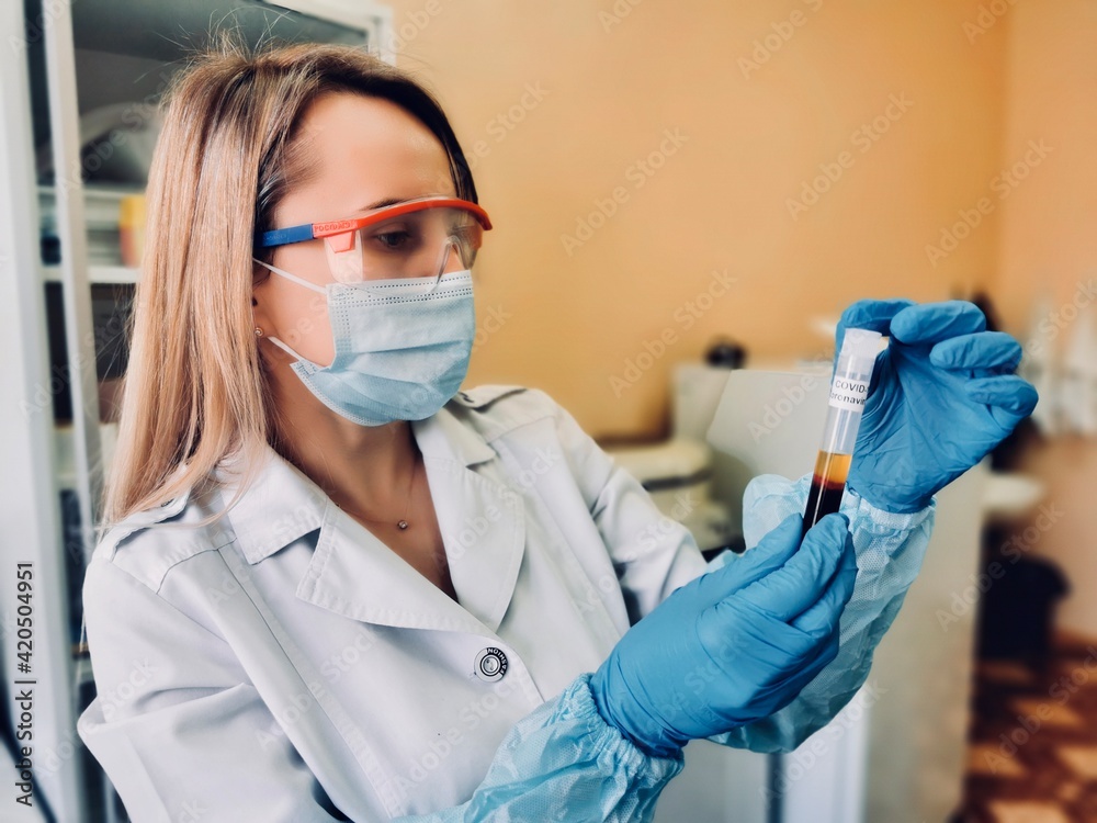 the doctor holds a test tube with blood for analysis for coronavirus the doctor holds a test tube with blood for analysis for coronavirus