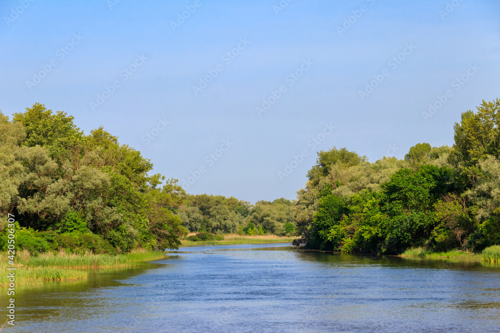 Spring landscape with beautiful river, green trees and blue sky Spring landscape with beautiful river, green trees and blue sky