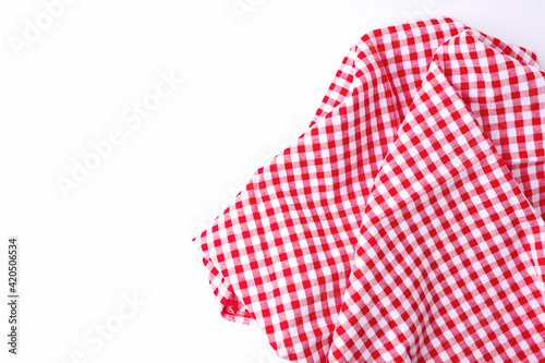 Red and white fabric tablecloth checkered on white background.