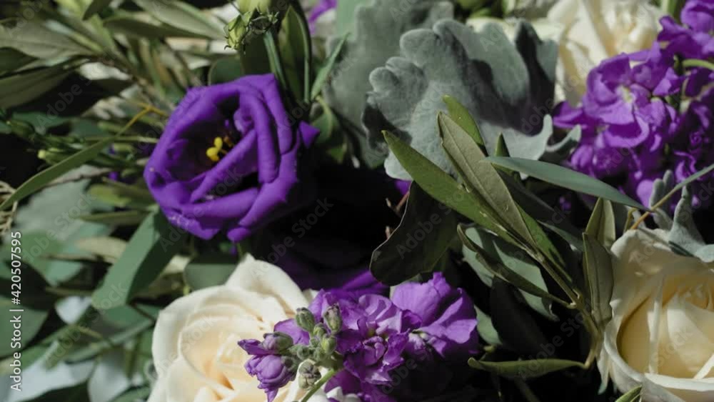 Elegant white and purple flower bouquet for a brides wedding laid out for viewing. Elegant white and purple flower bouquet for a brides wedding laid out for viewing.