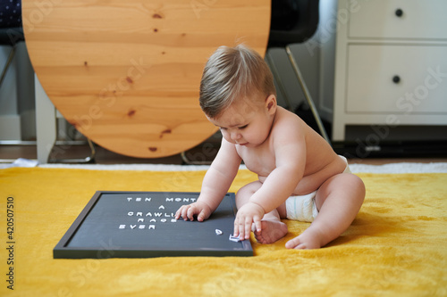 Baby playing with letters on board