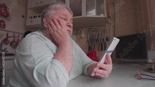 Senior Woman with Smartphone is waiting for a call