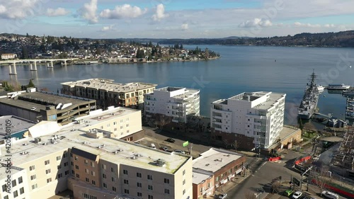 Cinematic aerial drone footage of Bremerton, Manette, Sinclair Inlet, Waterman, Puget Sound, the downtown marina, ferry terminal and shops in the background in Kitsap County, Washington State photo