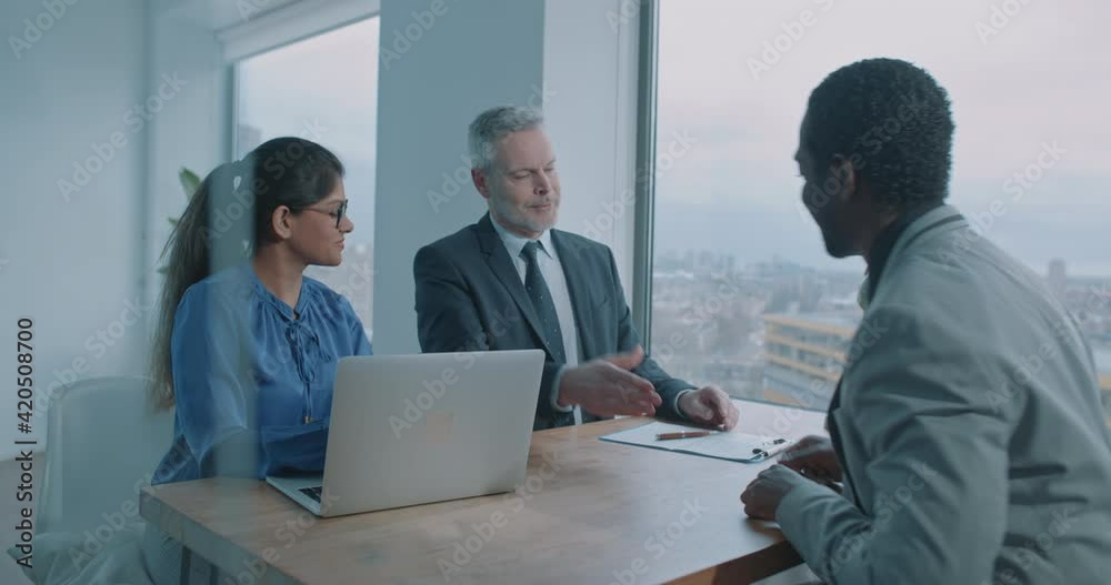 African businessman shake hands with recruiters and leave the room African businessman shake hands with recruiters and leave the room