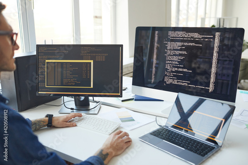 IT Programmer Writing Code on Computer Screen photo