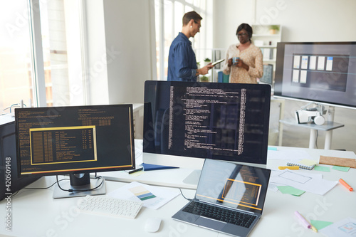 Computers with Code on Screen in IT Office