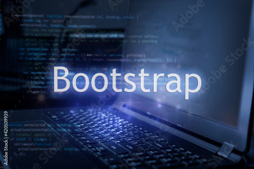 Bootstrap inscription against laptop and code background. photo