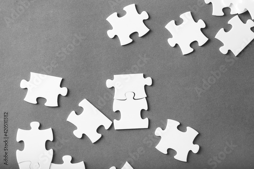 White puzzles on gray background top view