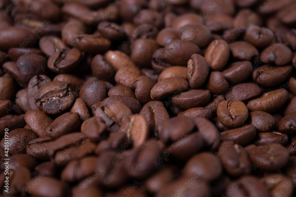 Fototapeta premium close up of Freshly roasted coffee beans background. top view