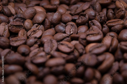 close up of Freshly roasted coffee beans background. top view