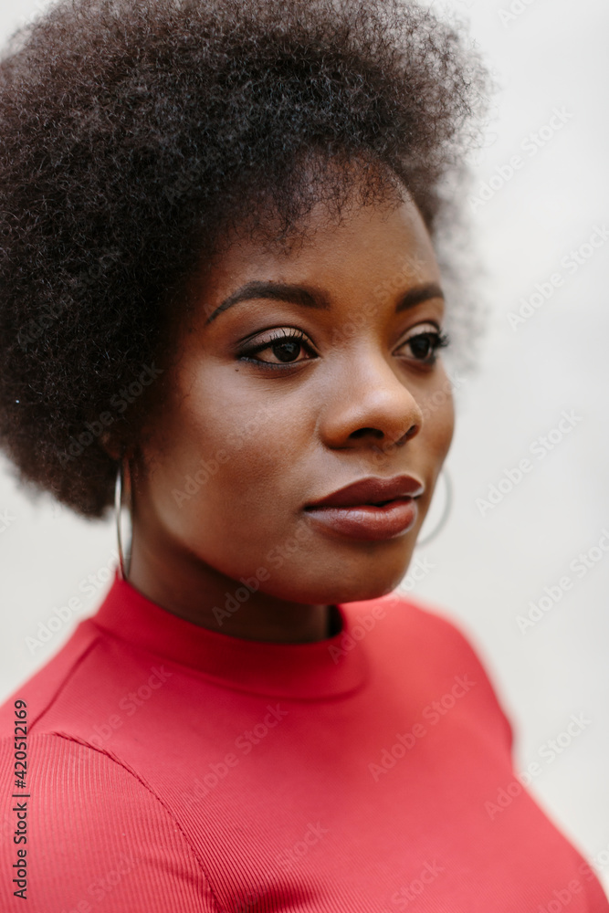 Closeup Portrait of attractive black woman in red looking to the side Closeup Portrait of attractive black woman in red looking to the side