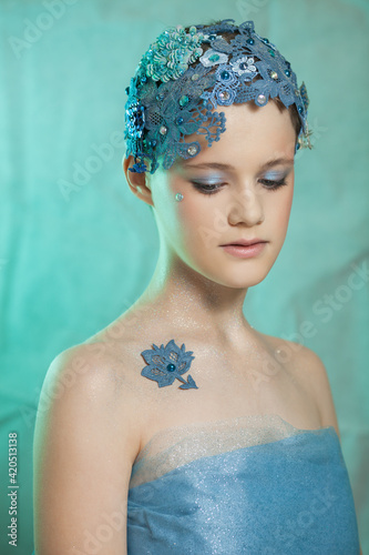 Girl in vintage style with blue lace on her head. photo