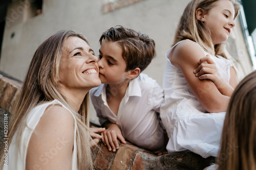 Son kissing the mother. Family portraits.