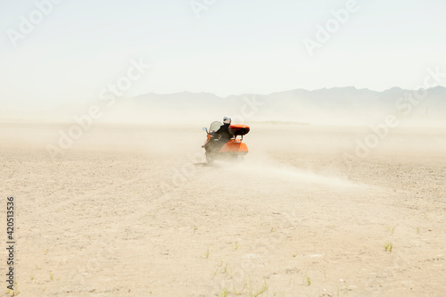 Man Driving a scooter in the desert photo