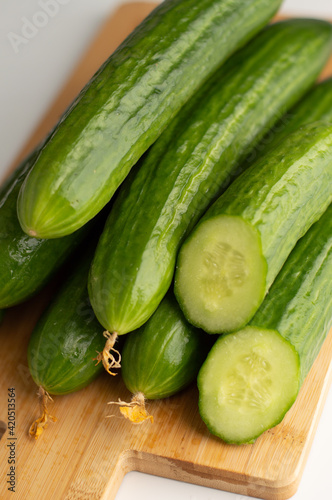 Fresh cucumbers on a cutting board.Photo with bokeh effect.Proper nutrition.