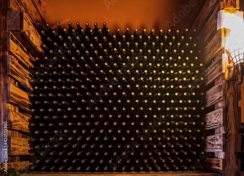 Wine bottles in wine cellar, row of glass bottles