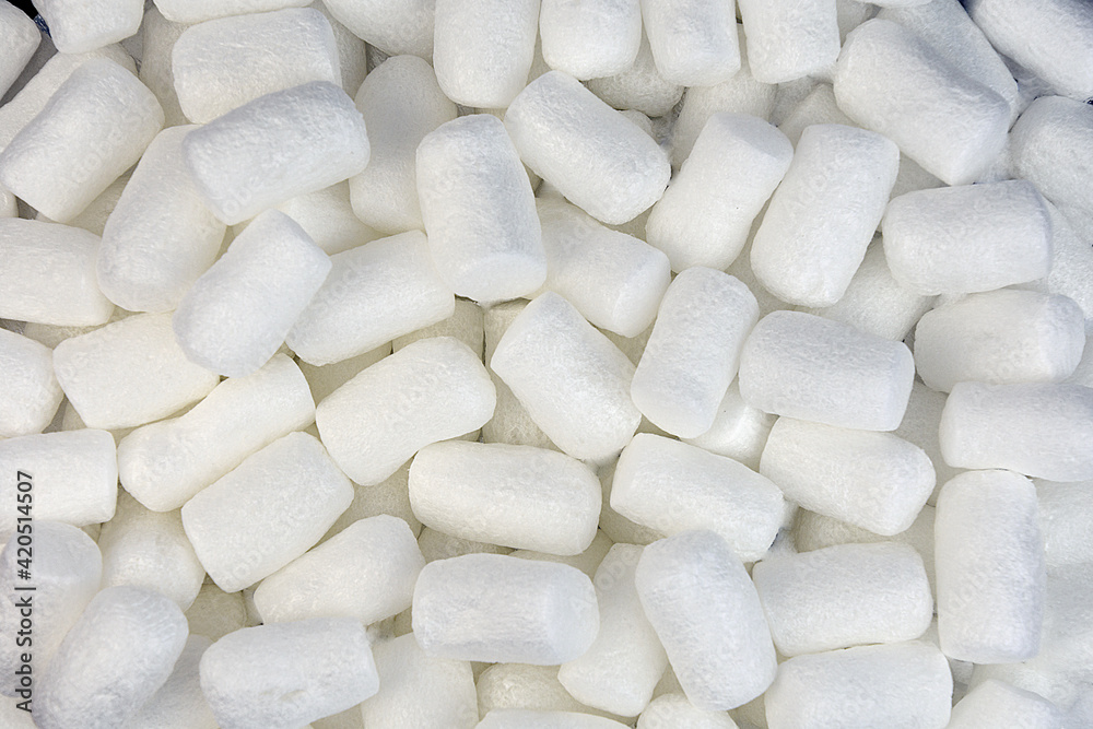 background of small white polystyrene foam cylinders background of small white polystyrene foam cylinders
