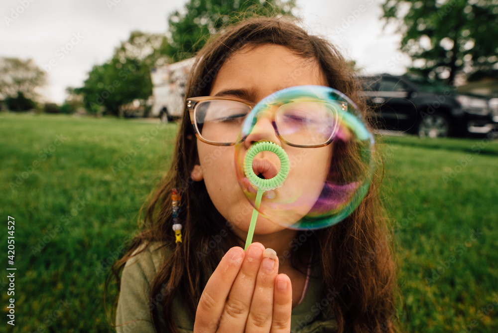 Girl having summertime fun blowing bubbles. Girl having summertime fun blowing bubbles.