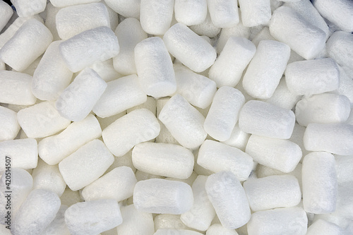 background of small white polystyrene foam cylinders