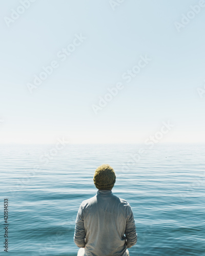man looking at the vastness of the lake photo